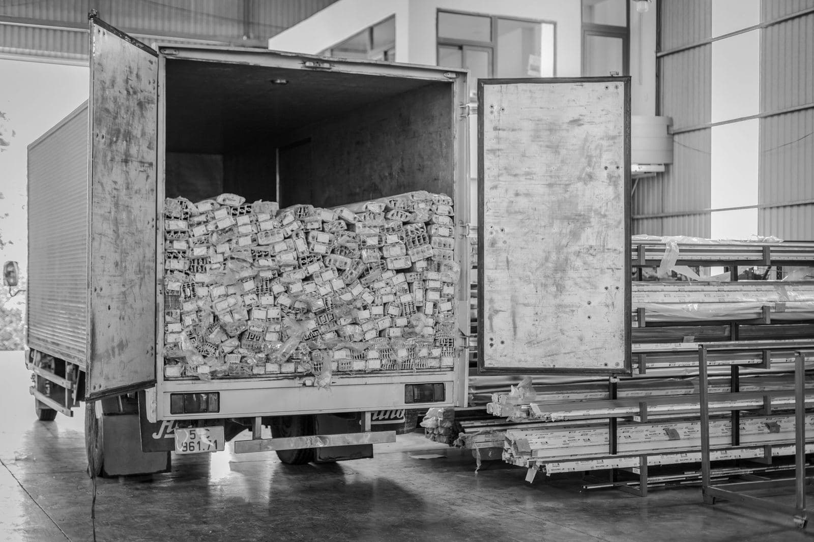 26-foot box truck with its rear doors open, loaded with freight